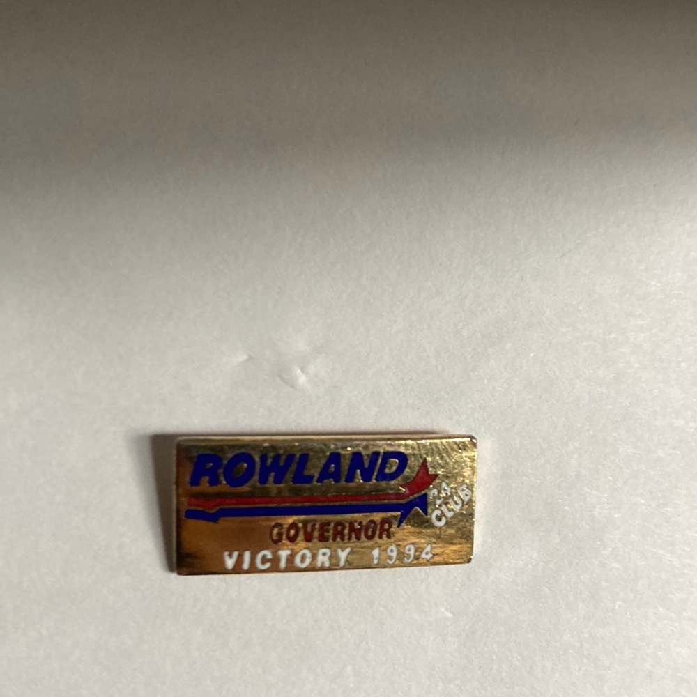 Z179- Small gold colored pin that says “ROWLAND Governor,victory 1994, 24 club”.